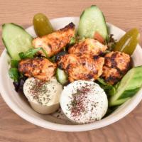 Fattoush Deluxe Salad · Traditional fattoush salad, topped with chicken shawerma or chicken kabob, served with garli...
