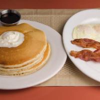 Pancake Combo · 2 pancakes, 2 eggs, 2 sausages and hash browns. Served with warm syrup and butter.