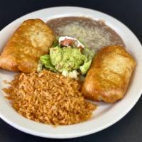 Chimichanga · 2 flour tortillas served chimichanga style, sour cream and guacamole. Served with rice, shre...