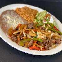 Steak Picado · Sliced, green pepper, mushrooms, onion and grilled togeth er.Served with rice, shredded lett...