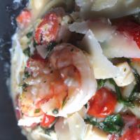LOBSTER RAVIOLI  · seared shrimp, lobster-ricotta ravioli, herbs, tomato, arugula, garlic cream  