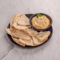 Hummus · Crushed garbanzo beans with tahini (sesame) sauce and lemon juice, topped with extra virgin ...