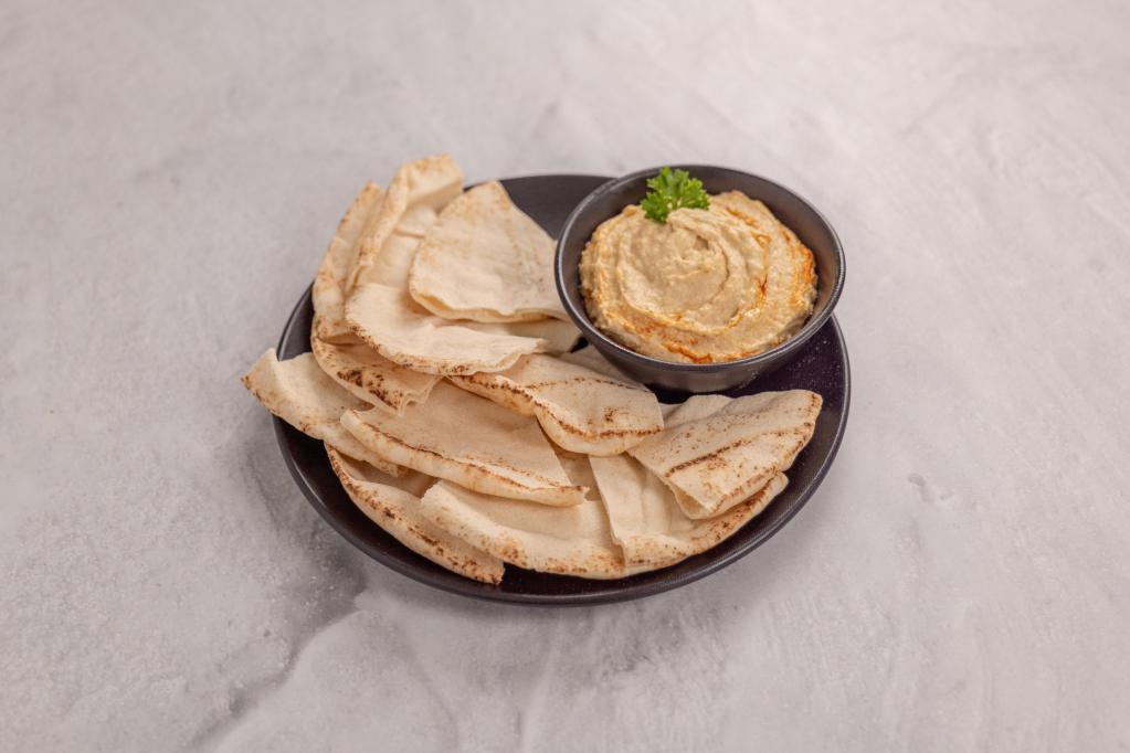 Hummus · Crushed garbanzo beans with tahini (sesame) sauce and lemon juice, topped with extra virgin olive oil. Served with pita bread.