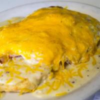 Arnold's Eggs · 2 eggs and ham on a buttermilk biscuit smothered with our own homemade gravy.