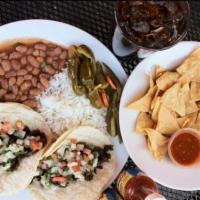 Carne Asada Taco Plate · Two grilled steak tacos served with rice, and yuca's pinto beans.