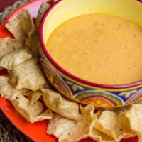 Chips & Queso · El Loco Carnicero Queso Dip made in our Butcher's Kitchen from Fresh Chipotle Peppers, Tomat...