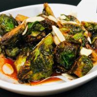 Caramelized Brussels Sprouts · Crispy Brussels sprouts, sweet corn and caramel fish sauce.