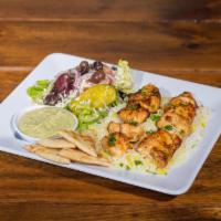 18. Chicken Souvlaki Platter · 2 skewers of marinated chicken breast, chardbroiled and cooked on a fire flamed grill. Serve...