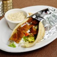 Lamb Gyro Sandwich · Marinated rotisserie lamb, tomatoes, onions, romaine lettuce and tzatziki wrapped in pita br...