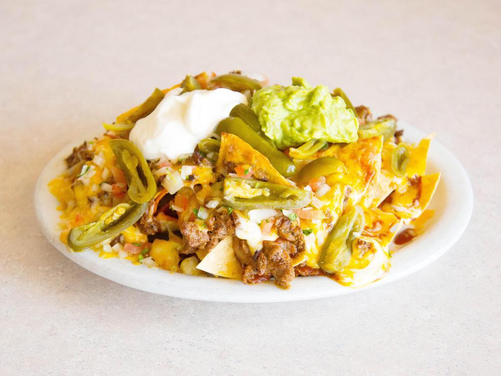 Cheese and Meat Nachos · Tortilla chips with cheddar cheese, beans, guacamole, sour cream, jalapenos, pico de gallo and your choice of meat.
