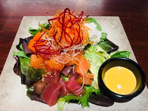 Kobe Tuna Poke Bowl · Salad with raw fish.