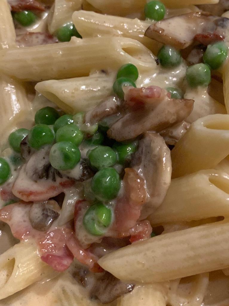Penne alla Spizzico · Mushrooms, pancetta and peas in a light cream sauce.