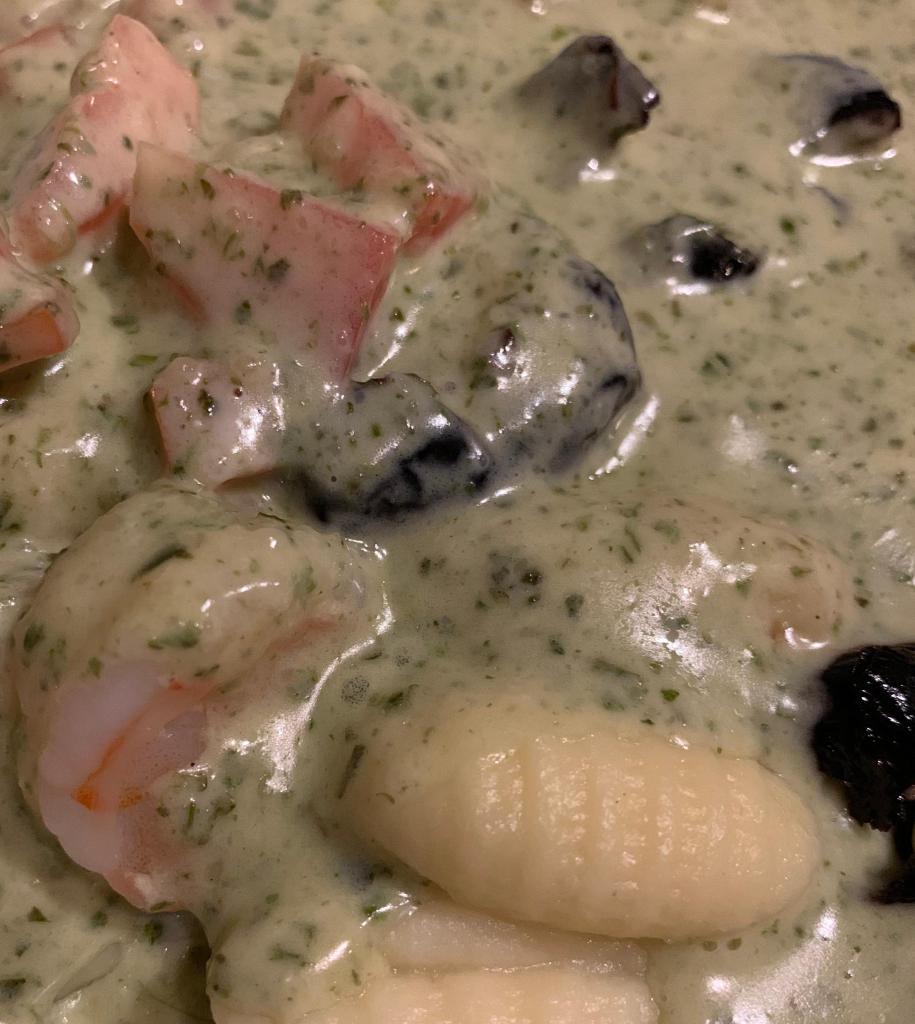 Gnocchi alla Spizzico · Potato dumplings, shrimp, black olives and tomatoes in our special pesto cream sauce .