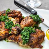 Roasted Chicken Dinner · Roasted half chicken, lemon, herbs, salsa verde, served with patatas bravas, roasted broccol...