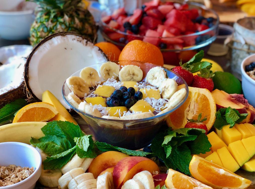ACAI Peach Bowl · Greek yogurt, banana, peach, honey, blueberry, mango, and coconut milk with granola on top.