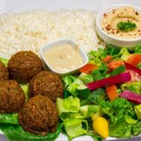 8. Falafel Plate · 5 pieces of falafel served with hummus, salad, tahini sauce, turnips and pita bread.