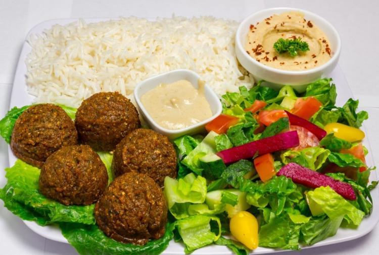 8. Falafel Plate · 5 pieces of falafel served with hummus, salad, tahini sauce, turnips and pita bread.