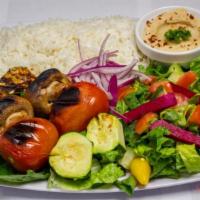 13. Veggie Kabob Plate · Marinated grill tomatoes, mushrooms, zucchini served with rice, salad, hummus, pita bread an...