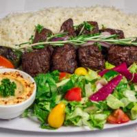 14. Lamb Kabob Plate · Marinated boneless lamb served with hummus, rice, salad, and pita bread.