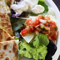 Quesadillas · Large flour tortilla filled with Jack and cheddar cheese, roasted chile poblano, grilled oni...