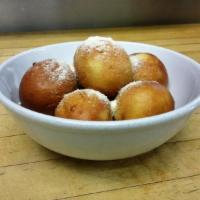 Romano Bread Puffs · Deep-fried, dipped in garlic sauce, and rolled in Parmesan cheese.
