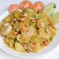 52. Pineapple Fried Rice · Fried rice with pineapple, raisin, cashew nut, eggs, curry powder, chicken and shrimp.