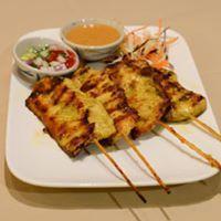 Chicken Satay · Grilled chicken marinated in Thai herbs served on a skewer with cucumber salad and peanut sa...