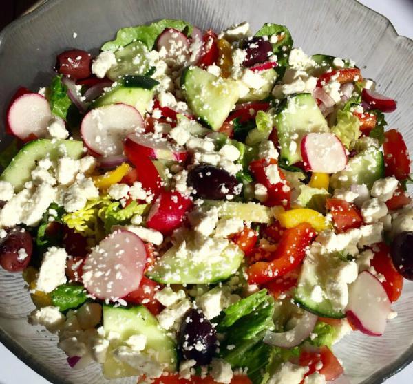 Greek Salad · Greek dressing, Romaine lettuce, tomato, cucumber, bell pepper, green and red onions, radishes, Greek olives and feta cheese.
