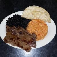 Carne Asada · Mexican style grilled steak. Includes rice, black beans and corn tortillas.