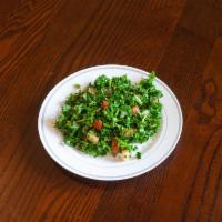 Tabbolih Salad · Fresh parsley finely chopped, mint, onions, tomatoes, bulgar, wheat and seasoned with olive ...