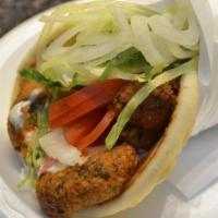 Falafel Wrap · Falafel topped with tomato, onion, cucumber, pickles, parsley, and tahini sauce. Includes fr...