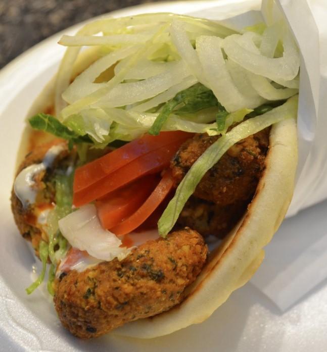 Falafel Wrap · Falafel topped with tomato, onion, cucumber, pickles, parsley, and tahini sauce. Includes french fries.
