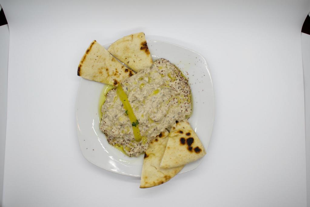 Baba Ghannouj and Pita · Mashed roasted eggplant adding a smoky flavor, mixed with fresh garlic, tahini, lemon juice and spices.