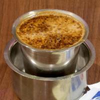 Madras Filter Coffee · Drink made by mixing frothed and boiled milk with ground coffee powder in a traditional Indi...