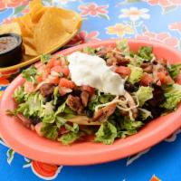 Tostada Salad · A crispy corn tortilla layered with choice of chicken, veggie, pulled pork, beef piccalillo,...