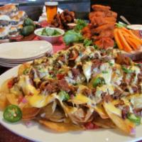 American Nachos · (Serves 5-7) Fresh potato chips topped with chili, red onion, tomatoes, jalapeños & American...
