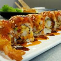 Volcano Ebi Roll · Shrimp tempura roll topped with baked mixed seafood and eel sauce.