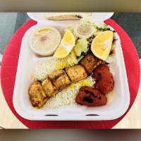 Salmon Kabob Combo Plate · Tender salmon, seasoned, and grilled served with Rice or French Fries, Salad, Pita Bread, wi...
