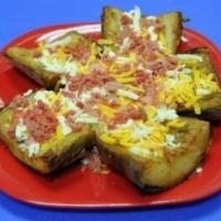 Potato Skins · Five home-made from real whole potatoes potato skins, topped with bacon, mozzarella and ched...