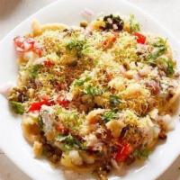 Chaat Papri · Chickpeas, crunchy wafers and potatoes topped with yogurt and tamarind sauce.
