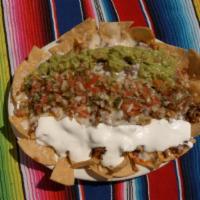 Super Nachos · Corn tortilla chips topped with refried beans, your choice of meat, cheese, sour cream, guac...