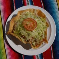 Taco Salad · Flour tortilla shell with whole pinto beans, rice, choice of meat, lettuce, guacamole, chees...
