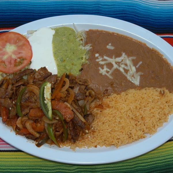 Bistec Ranchero Plate · Grilled steal sauteed with jalapeno peppers, onions, tomato and tomatillo sauce. Served with rice, re-fried beans, lettuce, sour cream, guacamole and corn or flour tortillas.