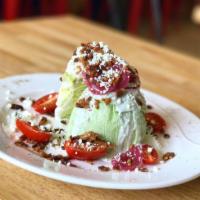 Wedge Salad · Iceberg lettuce, crumbled blue cheese, bacon, cherry tomatoes, pickled red onions and butter...
