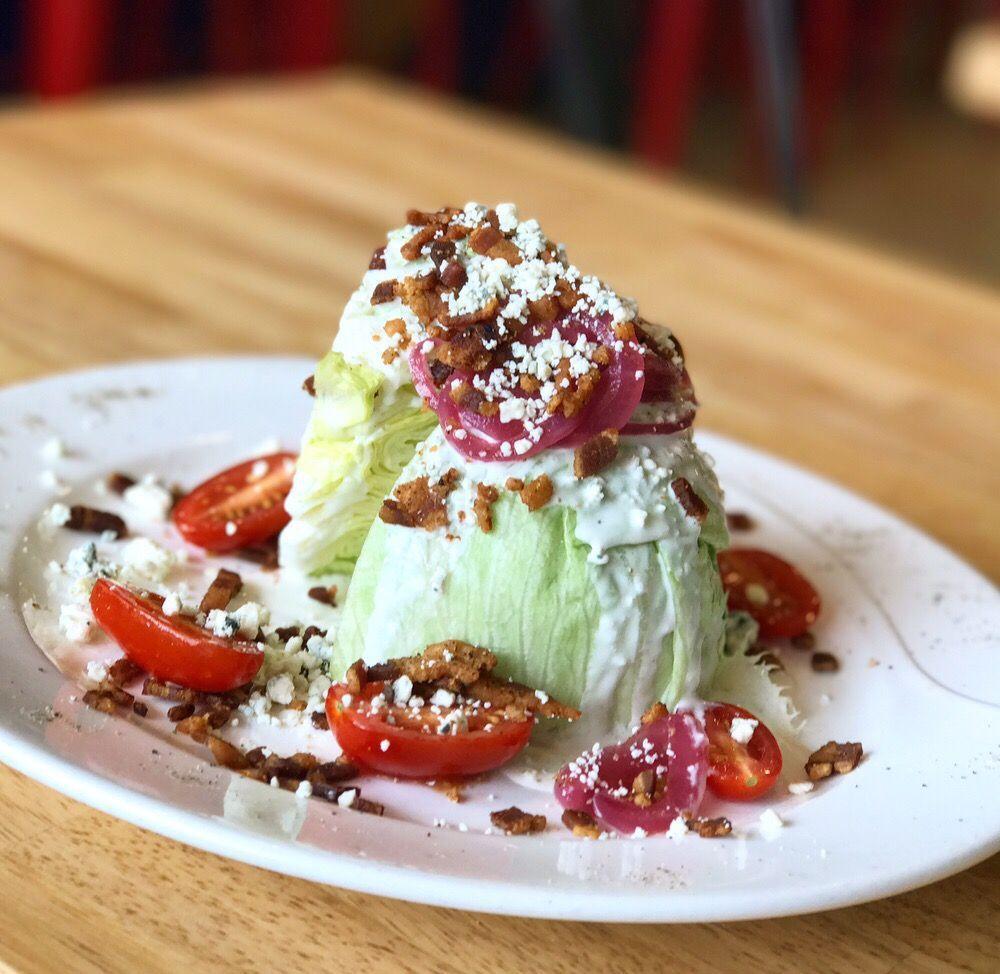 Wedge Salad · Iceberg lettuce, crumbled blue cheese, bacon, cherry tomatoes, pickled red onions and buttermilk blue cheese dressing. Gluten free.