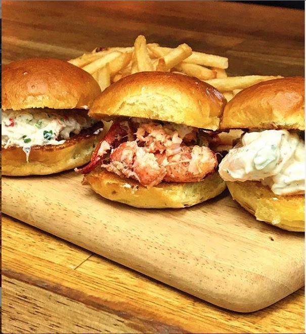 Seafood Slider · Maine style lobster salad, shrimp salad and crab salad on a brioche slider. Served with homemade coleslaw, pickles and choice of side.
