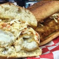 Beer Battered Cod Sandwich · Coleslaw and tartar sauce on ciabatta bread. Served with homemade coleslaw, pickles and choi...