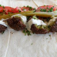 Vegetarian Falafel Wrap · 2 fried patties of chickpeas, parsley, onions, cilantro and spices, served on a pita with to...