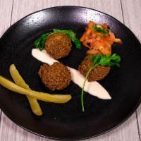Falafel Plate  · 4 pieces of falafel served with pita bread, tomatoes, parsley, pickles and tahini sauce.