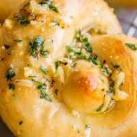 Garlic Knots · 2 pieces. Garlic knots drizzled in olive oil, garlic & Italian parsley. Served with a side o...